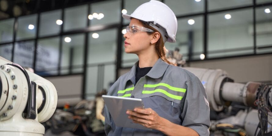 Woman engineer in a hard hat working with a clipboard - Civil PE Exam Work Experience Requirements - Petro Publications.