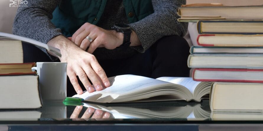 Faceless person studying notebooks - PE exam preparation materials with Petro Publications.